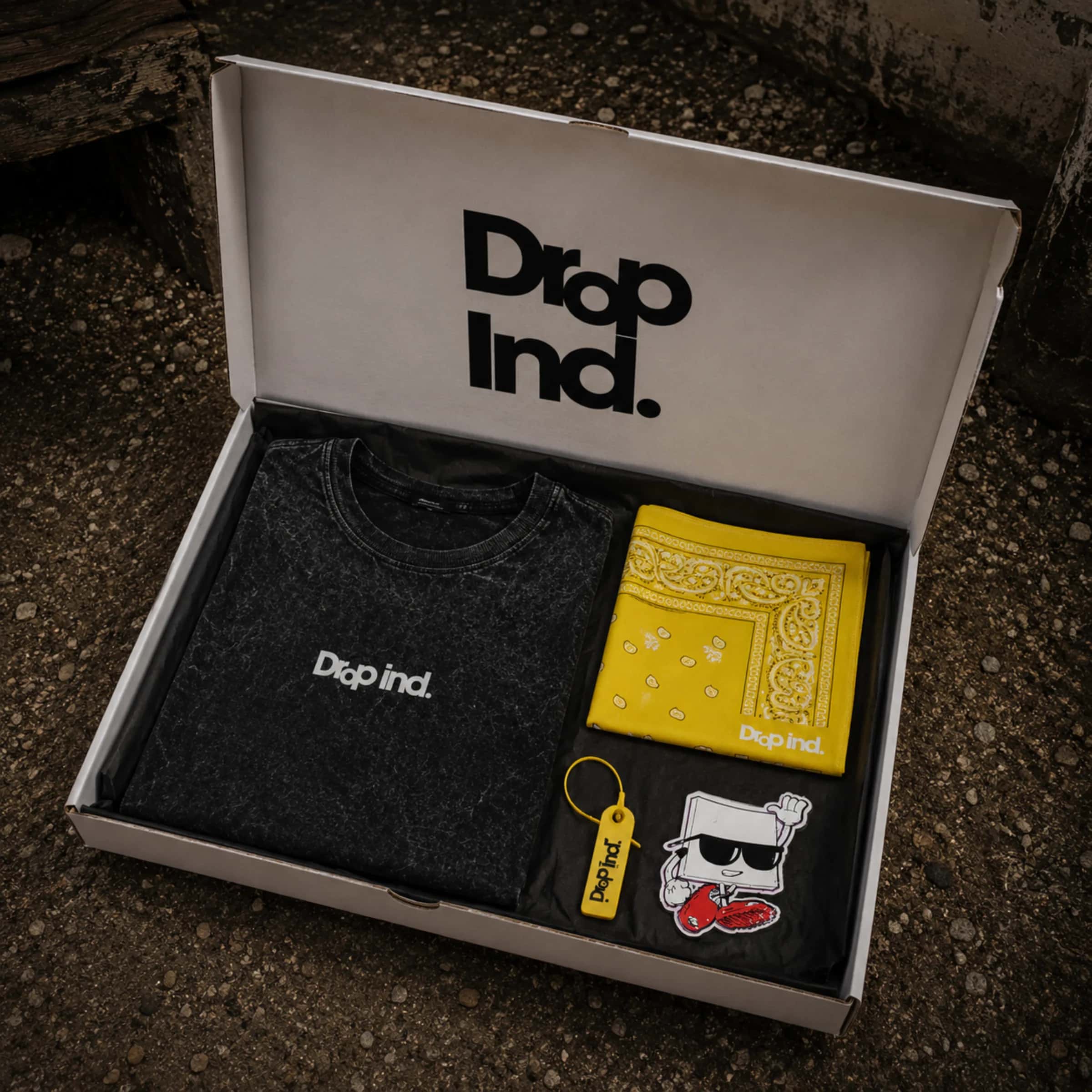 Drop 001 package with tee, bandana, NFC tag and sticker.